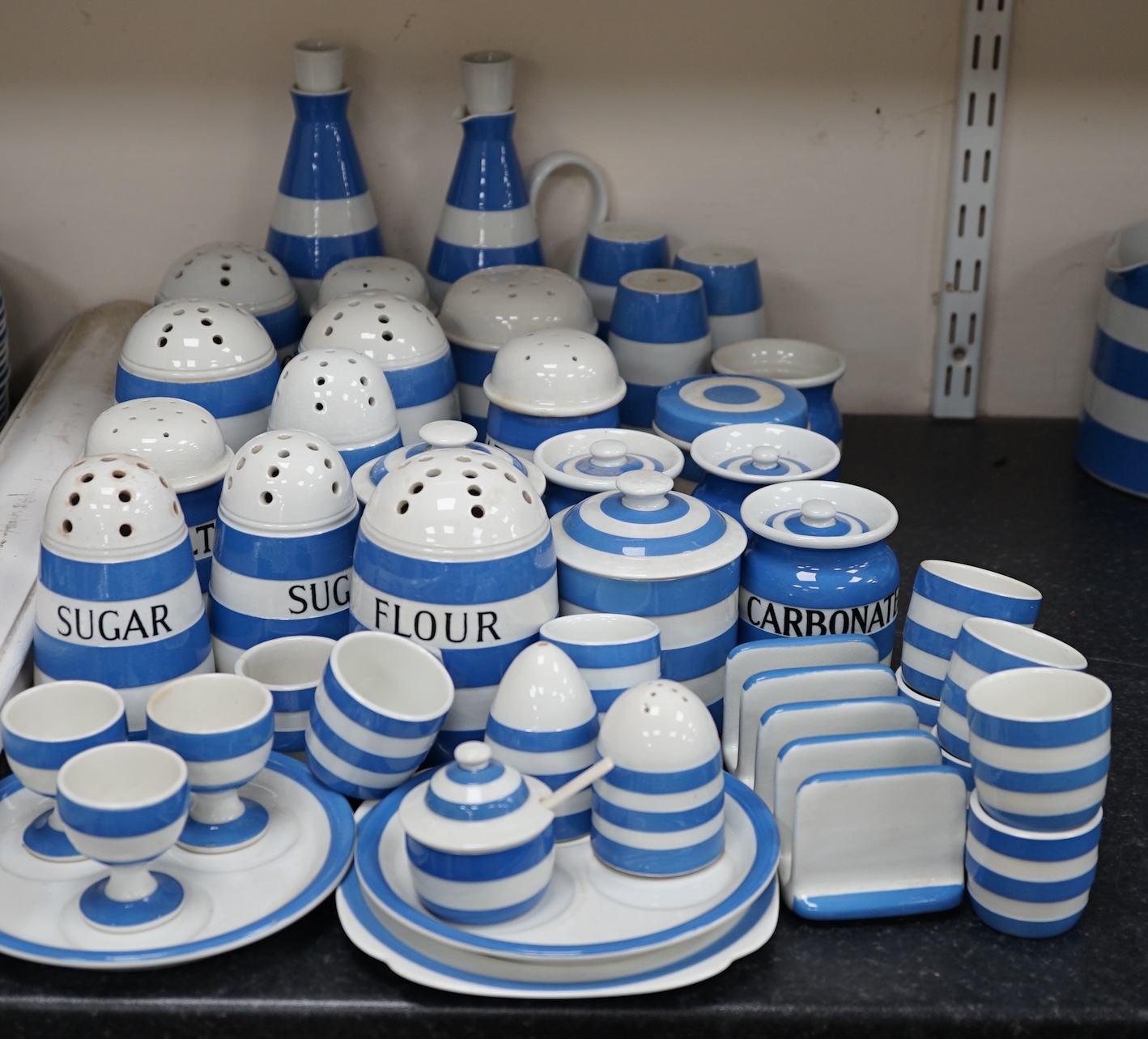 T.G.Green Cornish Kitchenware, a collection to include eleven flour, sugar, salt, brown flour and pepper shakers, six lidded jars, oil and sauce bottles, egg cruet etc, approximately thirty pieces, mixed marks. Condition